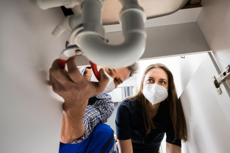 Plumber Fixing a Pipe